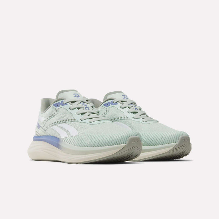 Women's Viva Speed Shoes by Reebok in light green with white and light blue accents, featuring a breathable mesh upper, lace closure, and a cushioned beige sole—ideal for comfortable runs. Shown on a plain white background.