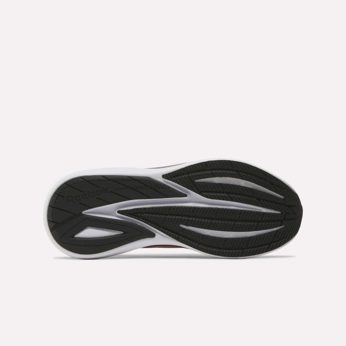 The image displays the black and white rubber outsole of the Women's Viva Speed Shoes by Reebok, showcasing grooves and textured patterns that provide traction. Designed to enhance grip in cushioned running footwear, the outsole also features an embossed Reebok logo on the left side.