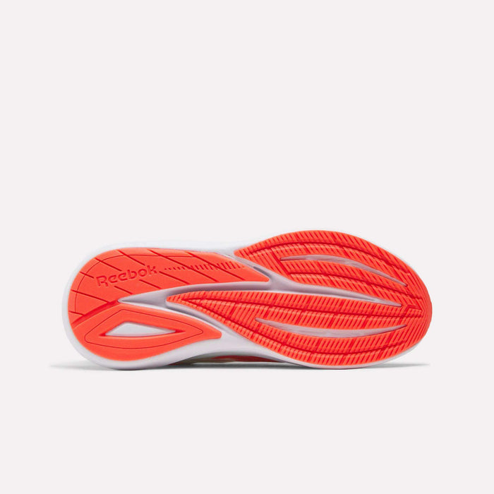 The underside of a women’s Reebok Viva Speed Shoe showcases a vibrant red and white sole with grooves and textured patterns for enhanced grip. Designed as cushioned running shoes, the Women's Viva Speed Shoes offer both comfort and support, with the Reebok logo prominently displayed on the left side of the sole.