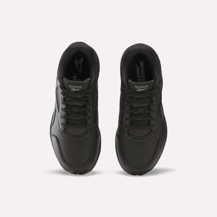 A pair of black Women’s Walk Ultra 7 DMX Max Shoes - Wide D by Reebok are placed side by side on a light background, viewed from above, displaying the laces, tongues featuring Reebok logos, and perforated toe boxes—designed for all-day comfort.
