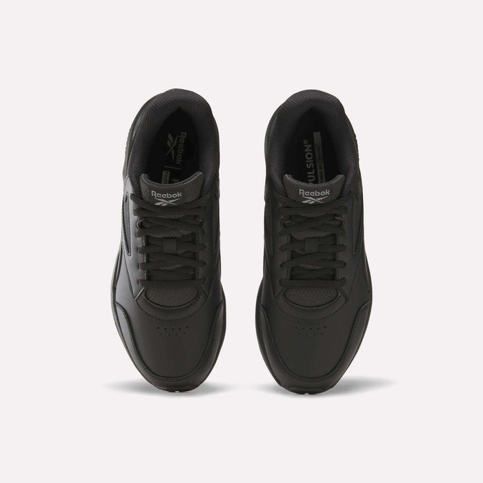 Top view of a pair of Women’s Walk Ultra 7 DMX Max Shoes by Reebok in black, featuring laces and positioned side by side on a plain white background. The Reebok logo is visible on the tongue and insole of each shoe, emphasizing their cushioned design for all-day comfort.