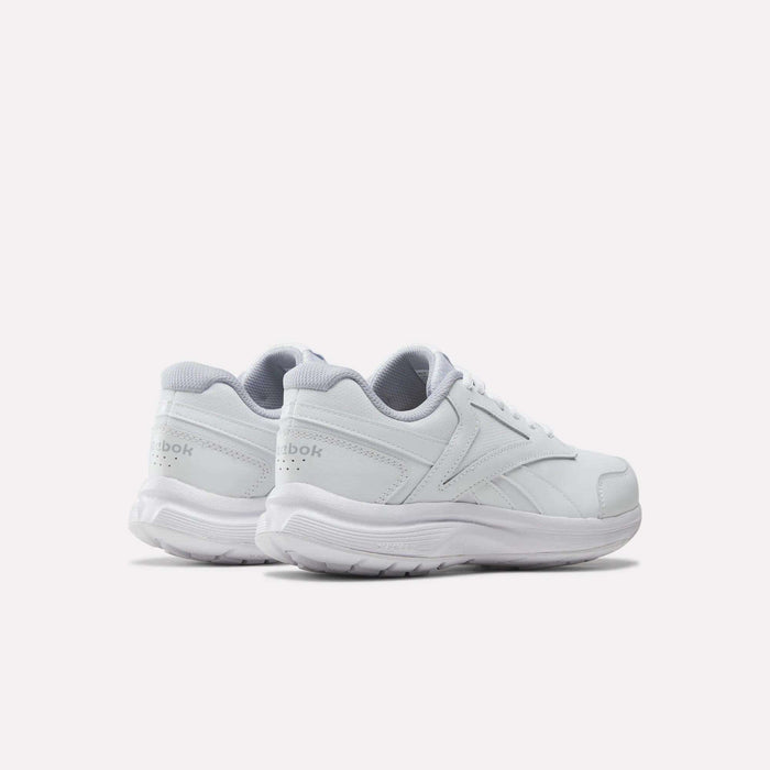 A pair of Reebok Women’s Walk Ultra 7 DMX Max Shoes in white with gray accents, seen from the rear left side, display the Reebok logo on the heel and feature a textured sole—these walking shoes are engineered for all-day comfort.