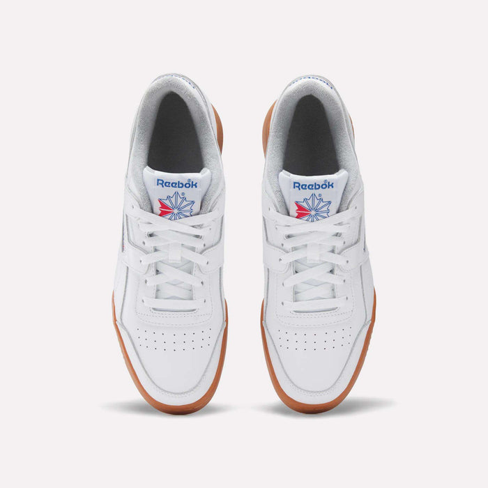 Top view of the Reebok Women's Workout Plus Shoes: classic white sneakers with brown gum soles, perforated toes, blue and red Reebok logos on the tongues, and a subtle '80s fitness vibe.