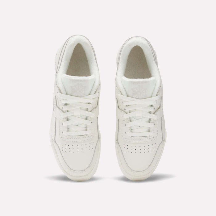 The Reebok Women's Workout Plus Shoes are shown from above on a plain white background, highlighting the laces, perforated toes, and logo details—ideal everyday workout sneakers.