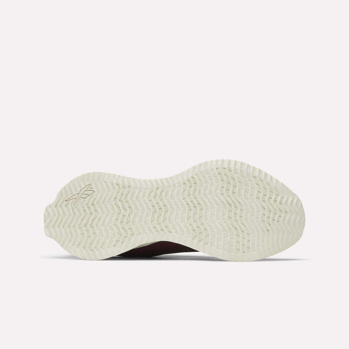The image displays the white rubber outsole of the Reebok Women's Zig Dynamica STR Shoes, featuring a wavy herringbone tread pattern, photographed from below against a plain light background.