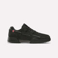 A black/black/grey4 Reebok Workout Plus Ripple Shoe featuring laces, a chunky ripple sole, and subtle Reebok branding on the side and heel is displayed on a plain white background—these weather-ready sneakers are designed for all-day comfort in any condition.