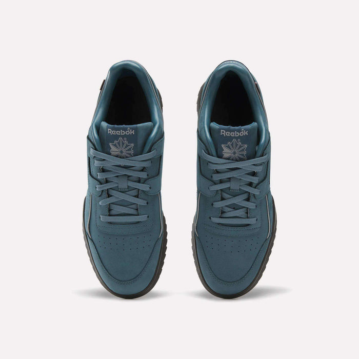 Top view of a pair of teal Reebok Workout Plus Ripple Shoes featuring laces, black ripple soles, and the Reebok logo with a starburst design on the tongue, placed side by side on a plain light background.