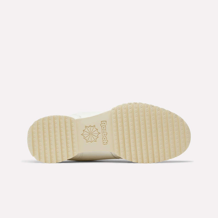 A cream-colored sole of the Reebok Workout Plus Ripple Shoes is shown from the bottom, featuring a ridged tread pattern, the Reebok logo, and a starburst design near the arch—classic details that capture the timeless appeal of vintage leather sneakers.