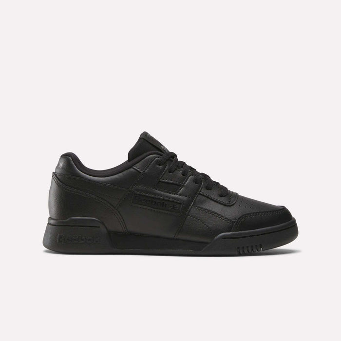 The Reebok Workout Plus Shoes - Big Kids feature a black low-top design with lace-up closure and classic Reebok branding, bringing retro style to juniors’ footwear, shown against a plain white background.