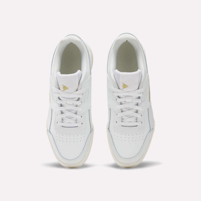 A pair of Reebok Workout Plus Shoes for big kids with laces, seen from above on a light background. These sporty white sneakers have perforated toe boxes and gold triangle logos on the tongues—ideal for juniors who want style and comfort.