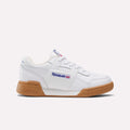 The Reebok Workout Plus Shoes for little kids feature a white design with gum sole, blue Reebok branding, and a small Union Jack on the side, shown against a simple light background.