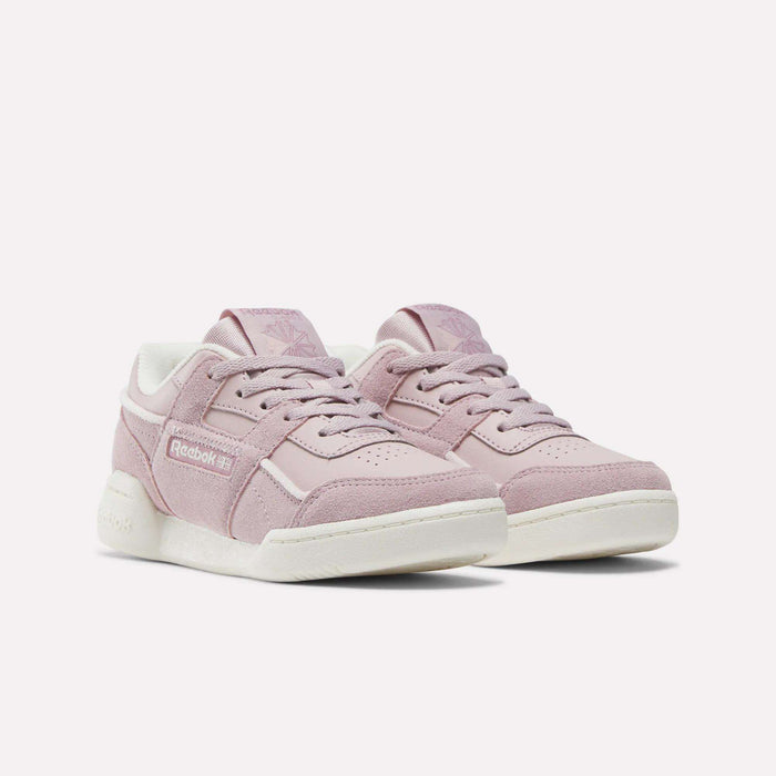 A pair of light pink Reebok Workout Plus Shoes for little kids featuring white soles, pink laces, and Reebok branding on the side and tongue, displayed on a plain white background.