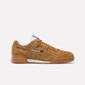 A single Reebok Workout Plus Shoe in brown suede with a gum sole, white lining, and side Reebok logo is displayed in profile against a plain light background, capturing the classic '80s fitness vibe.