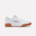 The Reebok Workout Plus Shoes feature a white design with gum soles, blue and red side logo accents, and white laces, showcasing classic '80s fitness style in a sleek profile against a plain light background.