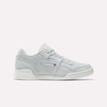 The Reebok Workout Plus Shoes feature a light gray suede finish, white sole, and subtle side branding. Displayed in side profile on a plain white background, they evoke classic '80s fitness style.