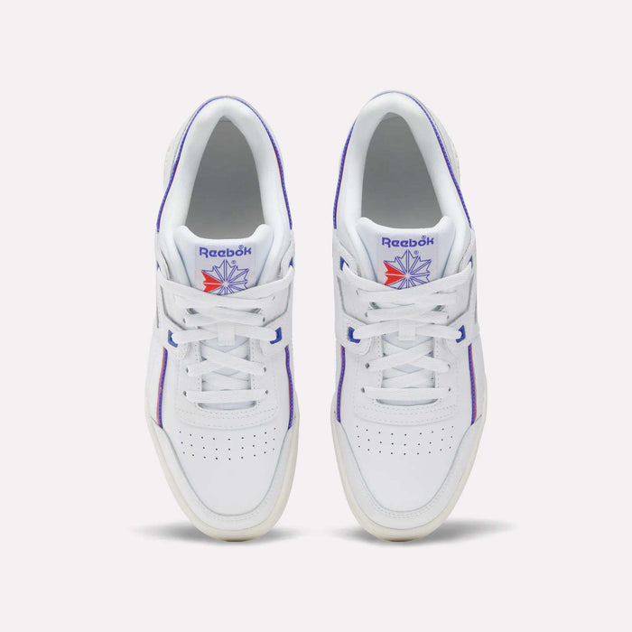 A pair of Women's Club C 85 Shoes by Reebok in white leather with purple accents and a blue and orange Reebok logo on the tongue, shown from above on a light background—classic women's sneakers with timeless style.