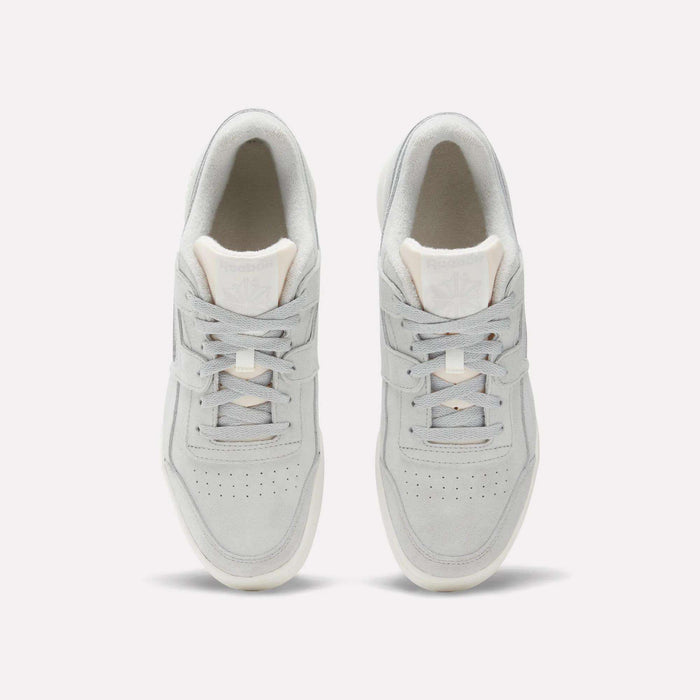 Top view of Reebok Workout Plus Shoes in light gray with white soles, laces, and subtle branding on the tongue. These classic sneakers channel authentic '80s fitness style and are shown side by side on a plain white background.