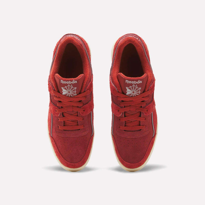 A top view of a pair of Reebok Workout Plus Shoes in red, featuring a white Reebok logo, visible stitching details, suede uppers, classic gum soles, and matching red laces, placed side by side on a plain white background.