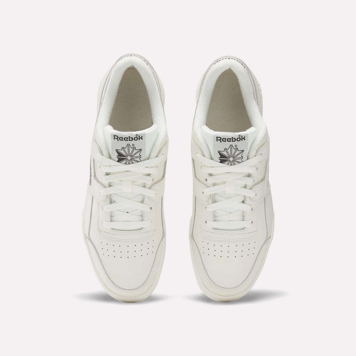 A pair of white Reebok Workout Plus Shoes viewed from above showcases classic '80s fitness style. The tops, laces, and Reebok logo on each tongue are visible, set against a plain light background.