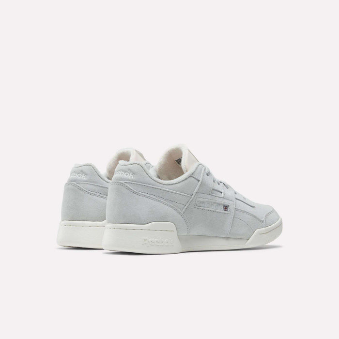A pair of Reebok Workout Plus Shoes in light gray suede with white soles, shown from the back and side on a plain white background. Features subtle Reebok branding and classic '80s fitness-inspired style.