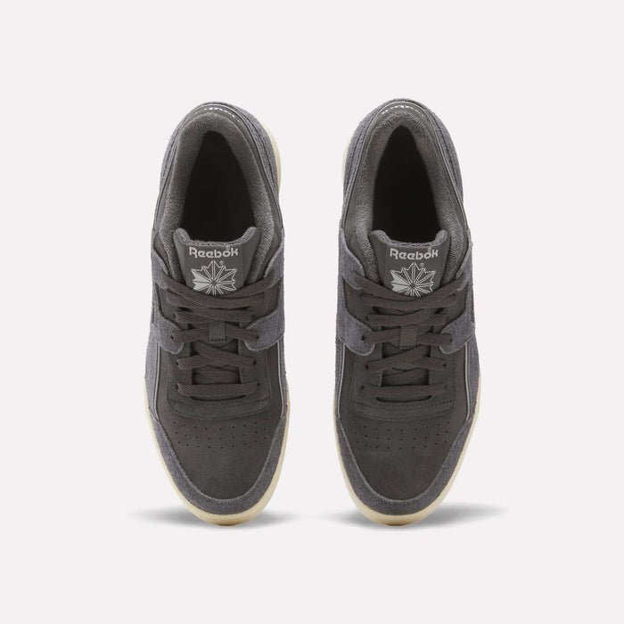 Top view of a pair of dark gray Reebok Workout Plus Shoes featuring laces, white Reebok logos on the tongues, a suede upper, perforated toes, and light outsoles on a plain white background.