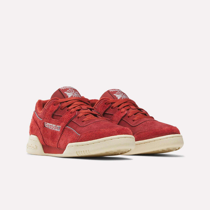 A pair of Reebok Workout Plus Shoes in vibrant red, crafted from soft suede with beige rubber soles, iconic Reebok logos on the side and tongue, and matching red laces. The shoes are displayed side by side against a plain white background.