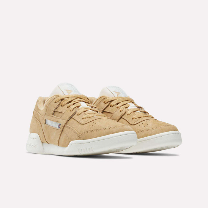 A pair of beige suede Reebok Workout Plus Shoes with white soles, beige laces, and subtle side and tongue branding, showcasing classic '80s fitness style against a plain white background.