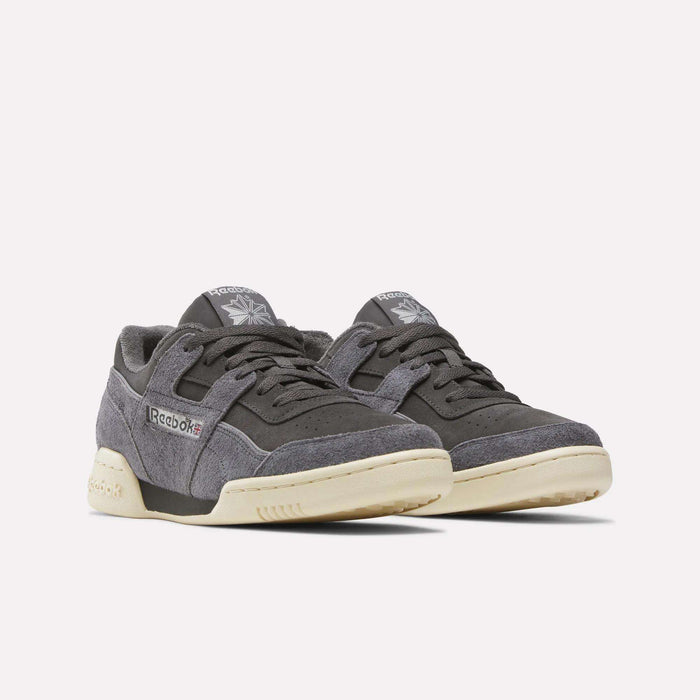 A pair of Reebok Workout Plus Shoes featuring a gray suede upper, mesh details, cream soles, and visible Reebok logos on the sides and tongues, displayed against a plain white background.
