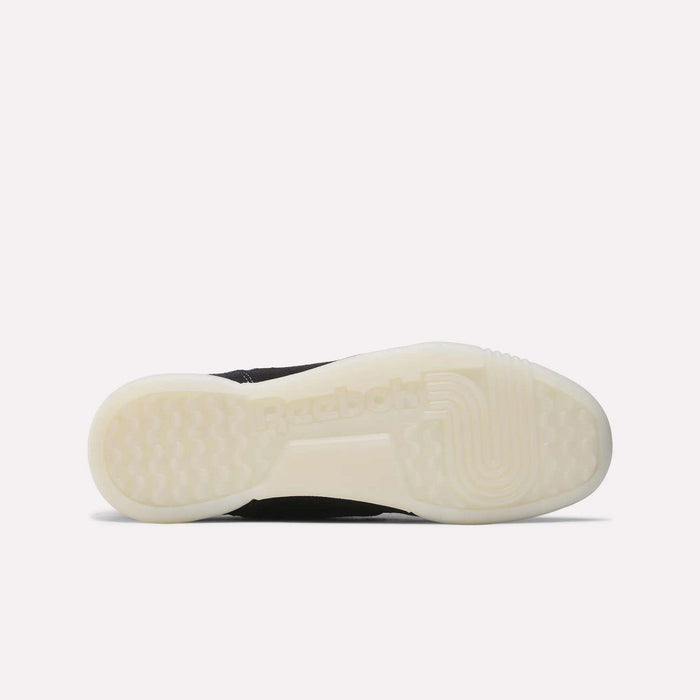 The image shows the bottom view of Reebok Workout Plus Shoes, highlighting a translucent, off-white rubber sole with textured grip patterns and the Reebok logo—evoking classic ’80s workout shoe style.