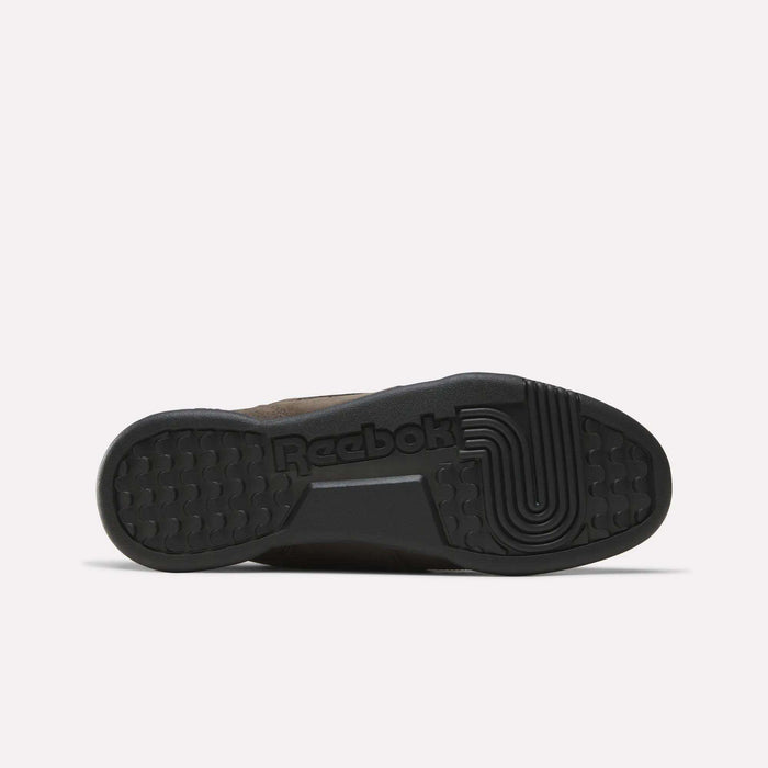 The image displays the black rubber sole of the Reebok Workout Plus Shoes, highlighting the Reebok logo and a distinctive circular pattern on the right side—an iconic element that underscores the timeless design found in every pair of classic Workout Plus Shoes by Reebok.