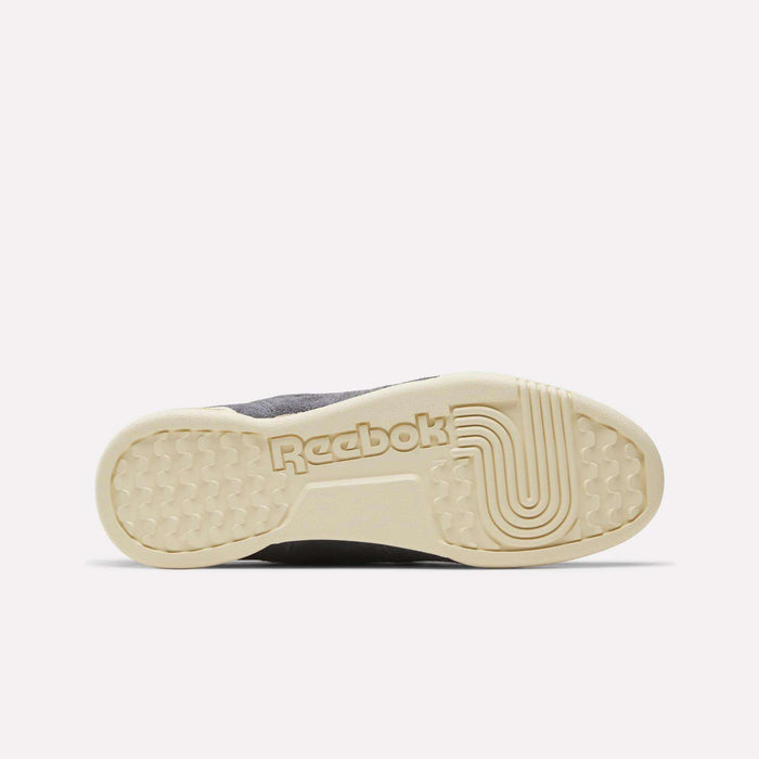 The image features the sole of Reebok Workout Plus Shoes facing upward. The light beige sole, embossed with the Reebok logo and curved line pattern, stands out against a plain white background, highlighting this archive-inspired classic.