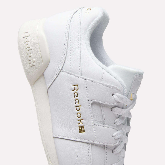 The Reebok Workout Plus Shoes feature crisp white leather, classic '80s-inspired style, and gold Reebok branding on the side and heel, shown against a light background.