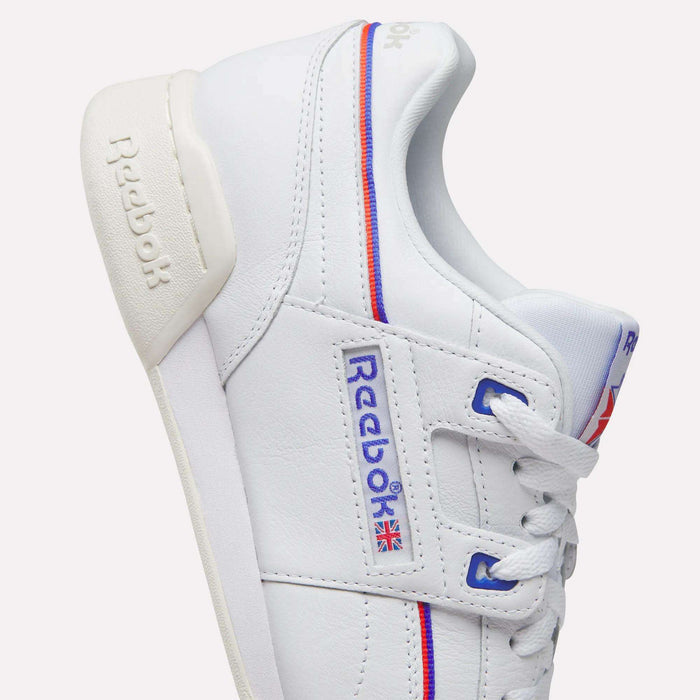 The Women's Club C 85 Shoes by Reebok feature white leather, blue and red accents, iconic logos, a small Union Jack flag, white laces, beige heel tab, detailed stitching, and a classic design.