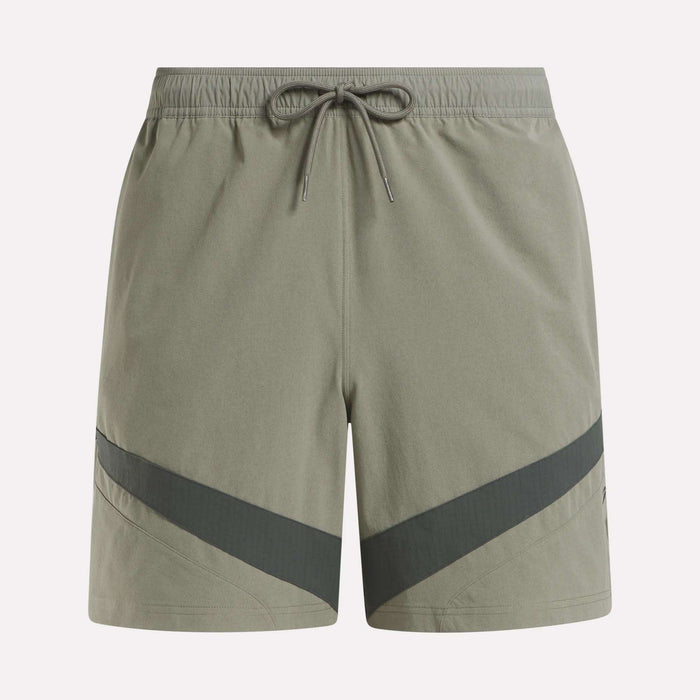 Reebok Woven Basketball Shorts in light olive green feature an elastic waistband with drawstring, dark diagonal stripes near the hem, and smooth, lightweight fabric—perfect for active wear or basketball enthusiasts.