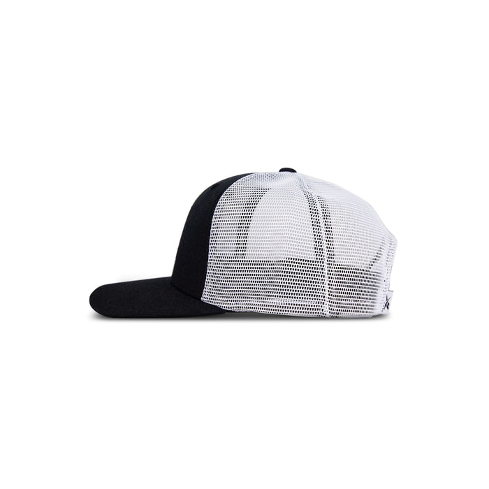 The Reebok Woven Patch Vector Trucker Cap features a black brim and front panel with a woven patch, white mesh back, and adjustable snapback.