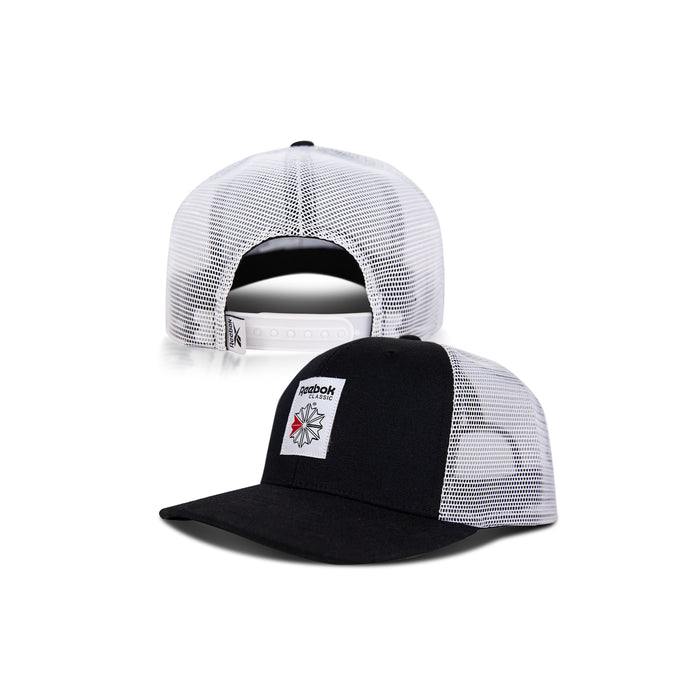 Front and back views of the Reebok Woven Patch Vector Trucker Cap: a black and white mesh hat with a curved brim, woven patch logo, and adjustable snapback closure.
