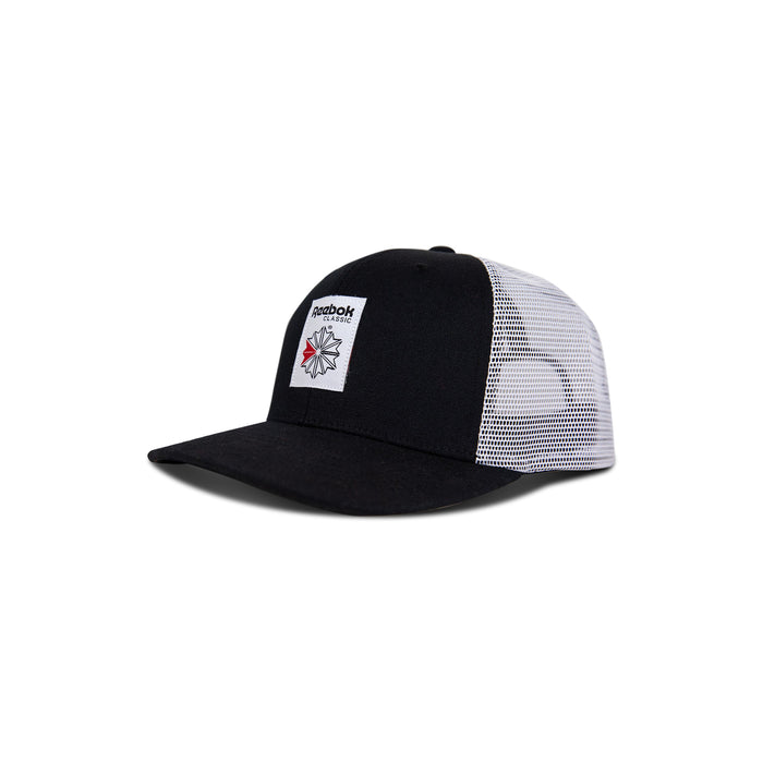 The Reebok Woven Patch Vector Trucker Cap features a solid black front with a woven patch logo and white mesh back panels. This flat-brim cap has an adjustable snapback for a perfect fit.