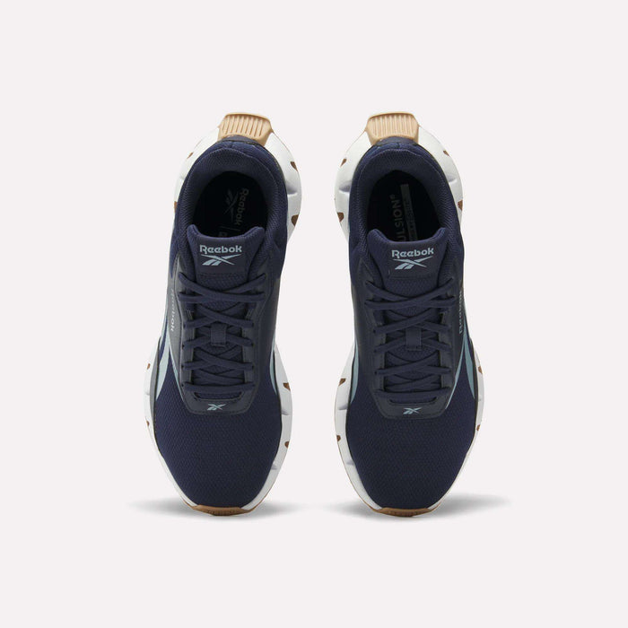 A pair of Reebok Zig Dynamica STR Shoes in dark blue with a breathable mesh upper, white soles, and brown accents, viewed from above on a plain white background.