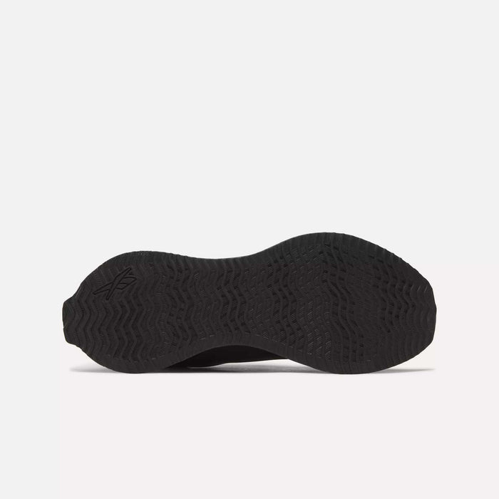Bottom view of the Reebok Zig Dynamica STR Shoes in black, featuring a textured rubber sole with wave and zigzag tread pattern, FuelFoam midsole cushioning, and a subtle logo by the heel—engineered for progressive running performance.