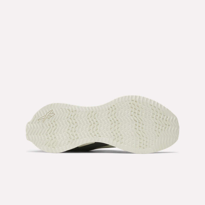 The image shows the white, textured sole of the Reebok Zig Dynamica STR Shoes, featuring a herringbone tread pattern and a small logo on the left side against a plain, light-colored background.