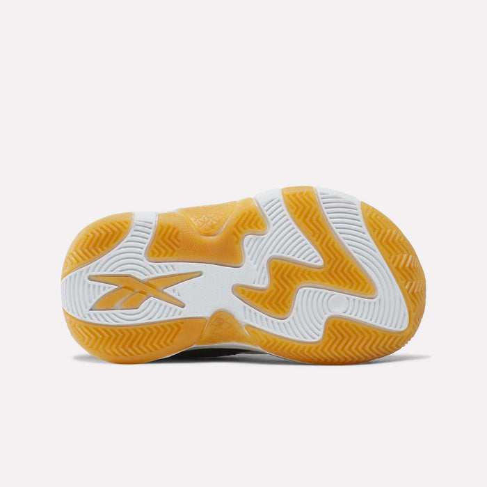 Bottom view of the Reebok Zone Breaker Shoes - Toddler, showcasing a textured sneaker sole with yellow and white sections and a Reebok logo on the left side, evoking the style of basketball shoes with ankle support—ideal for active boys.