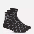 Three pairs of Reebok Zone Cushion Mid Crew Socks are shown side by side, each black with white Reebok logos and patterns, on a plain light background.
